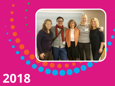 2018 text with a magenta background and a photograph of members of HRE USA 